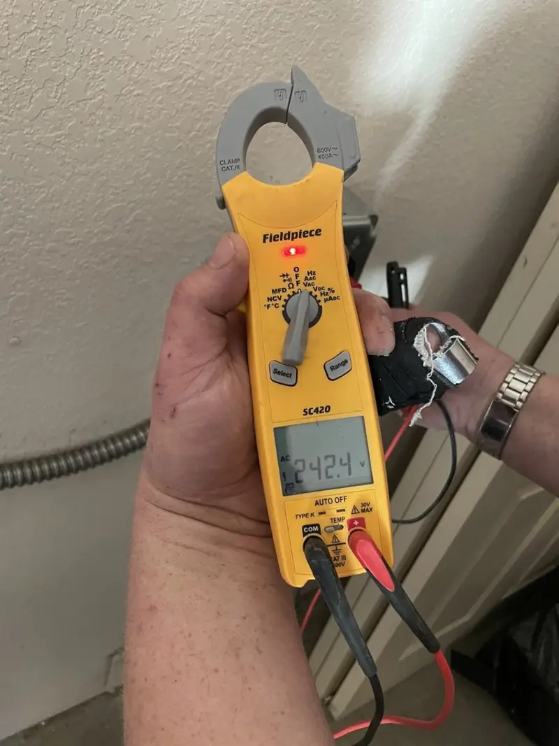 Voltage testing with clamp meter during Outlet Installation in Los Lunas